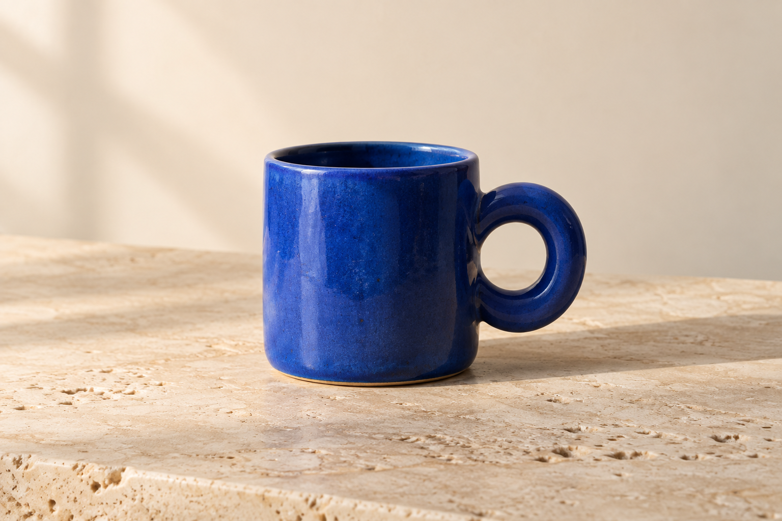 Response A: a blue ceramic mug on an ivory background
