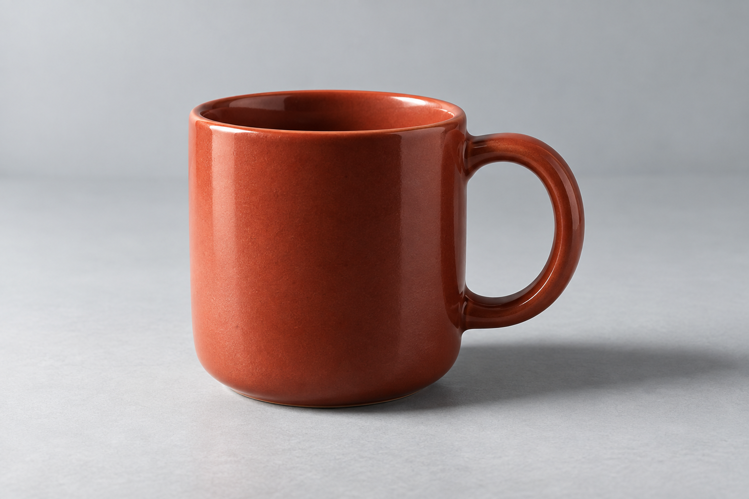Response B: a red ceramic mug on a cool gray background